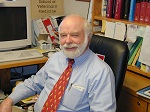 Bio photo of Dr/ Ronald Schultz sitting at his desk