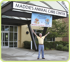 Man exulting in front of a building labeled 