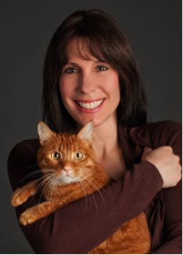 Bio photo of Carol Novello smiling and hugging an orange cat