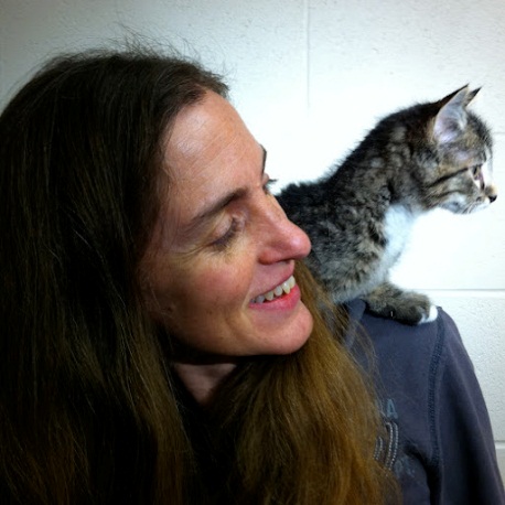 Bio photo of Dr. Sandra Newbury, smiling with a kitten on her left shoulder