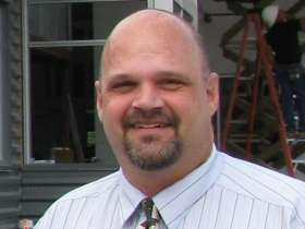 Bio photo of Scott Trebatoski in a white shirt, smiling