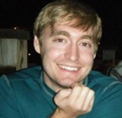 Bio photo of Kevin Horecka, smiling in a green shirt in an office setting