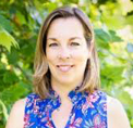 Bio photo of Monica Dangler, smiling in an outdoor setting