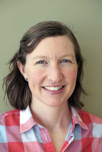 Bio photo of Dr. Lena DeTar, smiling in a red gingham pattern shirt