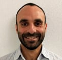 Bio photo of Dr. Mike Greenberg smiling in front of a light background