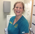 Bio photo of Dr. Sarah Boyd, smiling in blue scrubs