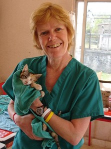 Bio photo of Dr. Sheilah Robertson, i green scrubs holding a little kitten 