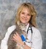 Bio photo of Susan B. Krebsbach smiling in a white lab coat, holding a gray cat