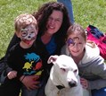 Photo of Dr. Sheila D'Arpino smiling with two children and a white dog