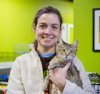 Bio photo of Dr. Ellen Jefferson smiling in a lab coat holding a kitten